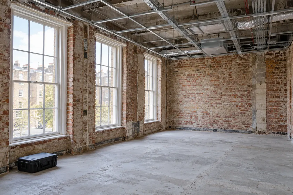 Vacant commercial interior with exposed ceiling void ready for investigation
